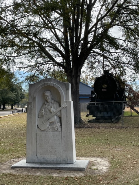 Jimmie Rodgers marker in front of a train in Highland Park, Meridian, MS. Photo taken by and the property of FourWalls. Jimmie Rodgers marker in front of a train in Highland Park, Meridian, MS. Photo taken by and the property of FourWalls.