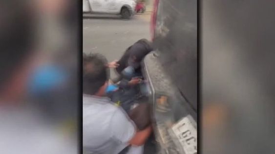 John Lally  (Back turned) assists a wounded police officer who was wounded in shootout