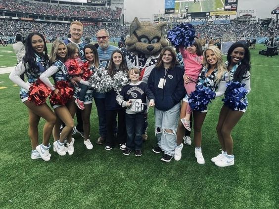 Seth Cole with his relatives and Titans cheerleaders at Nissan Stadium in Nashville 