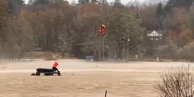 U S Coast Guard on a mission to rescue persons trapped in a flood in Washington state