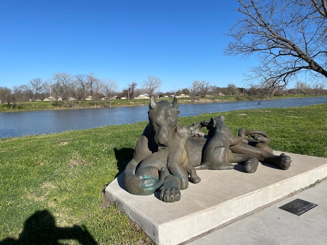 Sculpture of a lioness with her cubs on the river bank, with the Brazos in the background. Photo taken by and the property of FourWalls. Sculpture of a lioness with her cubs on the river bank, with the Brazos in the background. Photo taken by and the property of FourWalls.