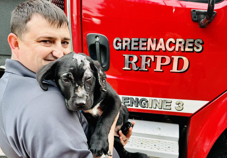 Volunteer fire chief Corey Bryant with his new adopted dog Smoky