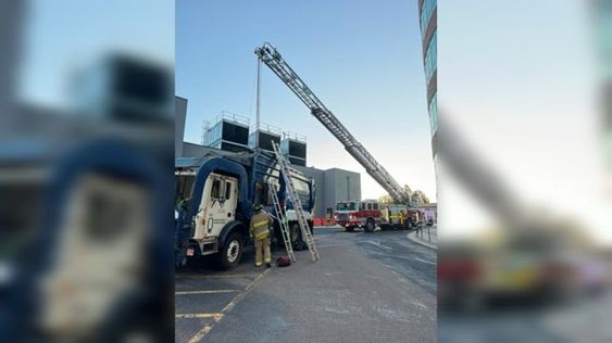 Colorado Springs Firefighters rescue a man trapped inside of a garbage truck