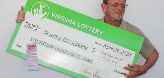 Virginia lottery winner Timothy Clougherty with his winning lottery check Virginia lottery winner Timothy Clougherty with his winning lottery check