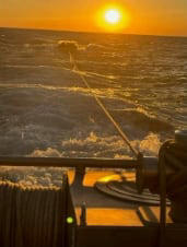 A boat in Lake Erie being rescued by the USCG