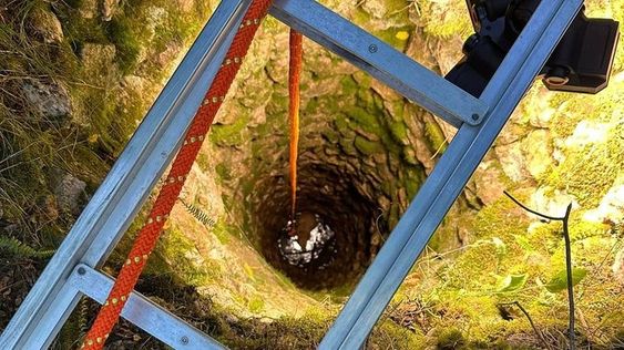A dog being rescued by firefighters in Virginia at an abandoned well A dog being rescued by firefighters in Virginia at an abandoned well