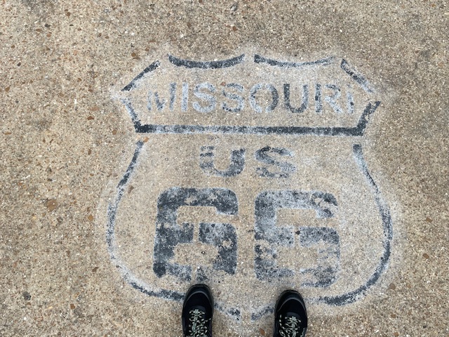 Route 66 sign on the road in the state park, complete with my feet!  Photo taken by and the property of FourWalls.