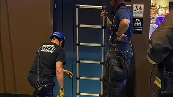 Firefighters rescue three persons trapped inside of an elevator Firefighters rescue three persons trapped inside of an elevator