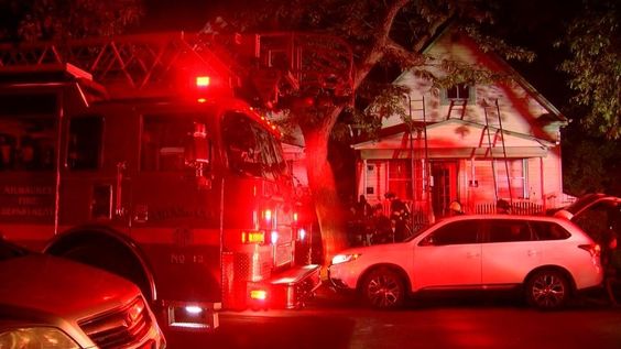 Firefighters in Milwaukee douse a house fire on Tuesday morning