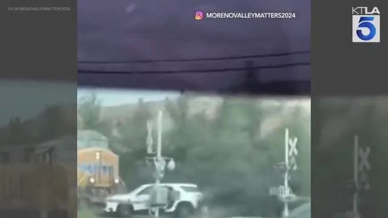 A train in California about to hit a SUV that was a railroad track crossing.