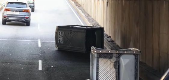 2 porta potties fall off of a truck in Cambridge Massachusetts