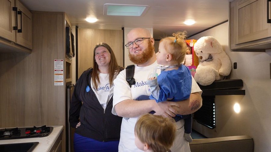 The King family in front of a camper in Las Vegas getting their wish come true.