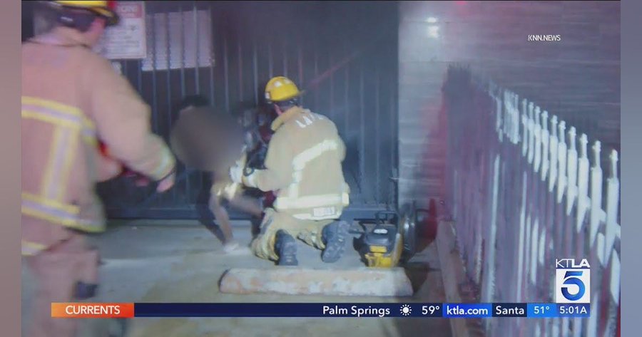 Firefighters in Los Angeles rescue two persons in a house fire.  