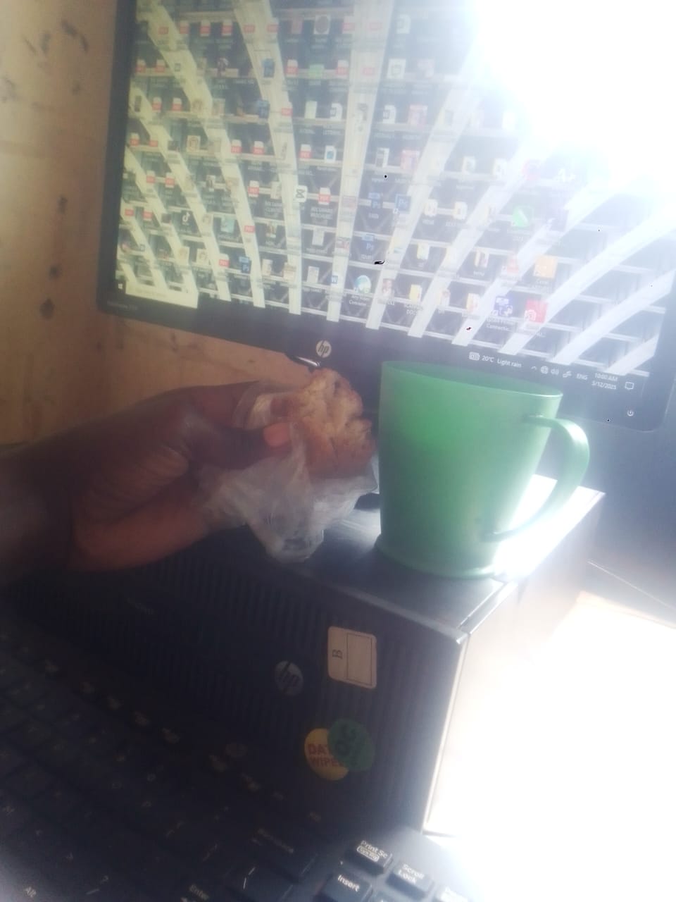 A photo of me holding a piece of hardcore cake and a cup of porridge on my CPU, while i was having breakfast