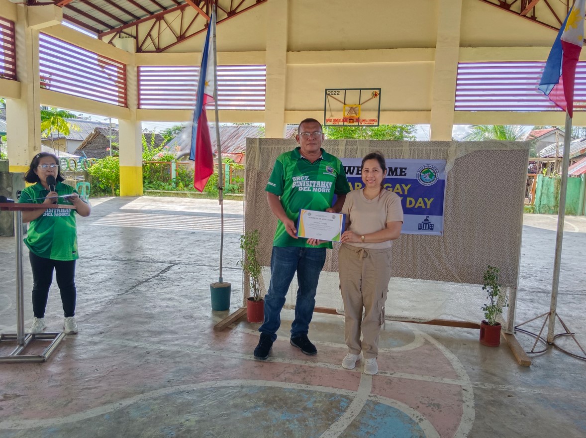 Me while receiving a certificate of appreciation from the chief of the village