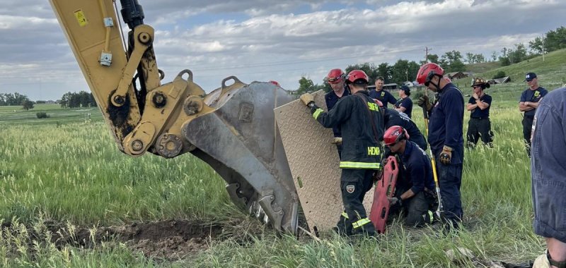 Firefighters and construction workers rescue a lost dog who was in a trench.