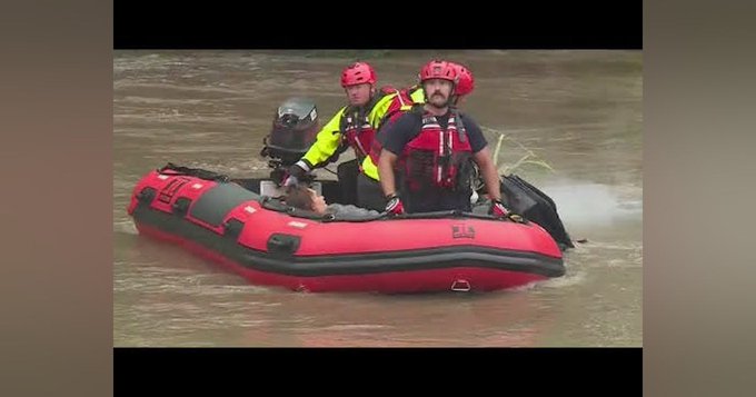 Kansas City Missouri firefighters to the rescue of a woman needing help during a flood.