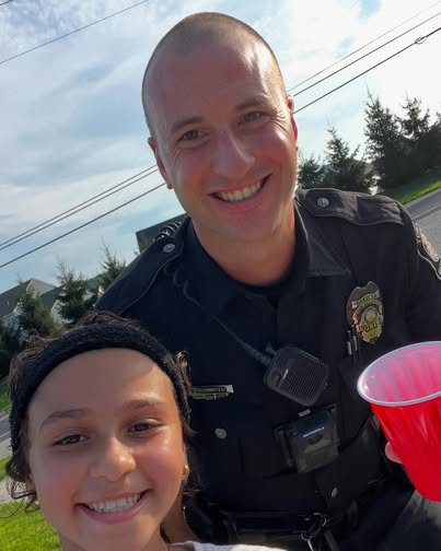 Girl who runs a lemonade stand in Upper Allen Pennsylvania with a police officer fan.