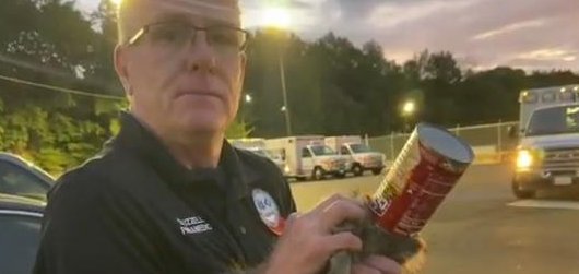 Paramedic in Little Rock Arkansas with a soup can that was removed from a raccoon. 