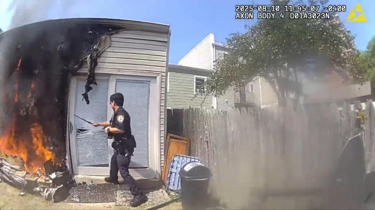 New York Police Department officers save two men a dog in a house fire.
