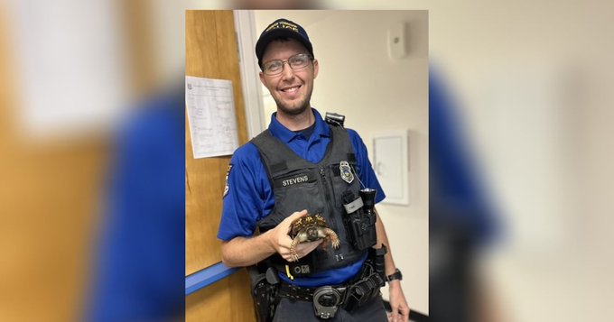 Montogomery County Police Officer Stevens with a turtle he rescued on a highway.