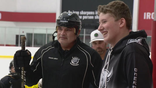 San Antonio firefighter Mike Leroy with teen ice hockey player Grady Renmeka