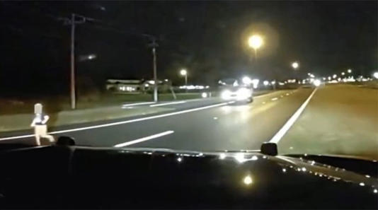 Child running on a highway in Florida. 