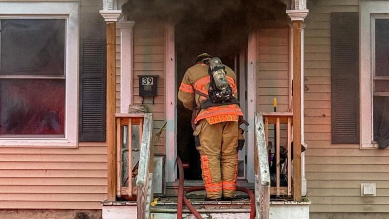 Firefighter in Auburn New York at a scene of a house fire 