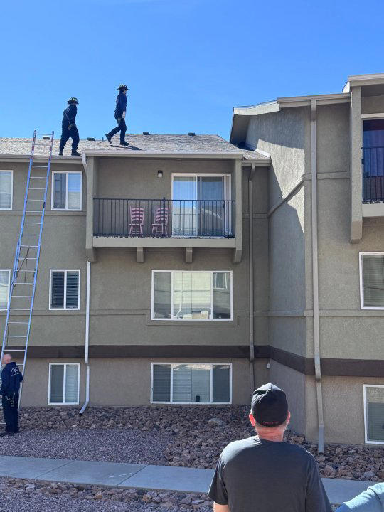 Firefighters in Colorado Springs Colorado rescue a cat that was stuck in a roof