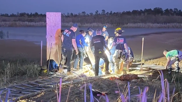 Police officers rescue a man who was stuck in a borrow pit in Jacksonville FL 