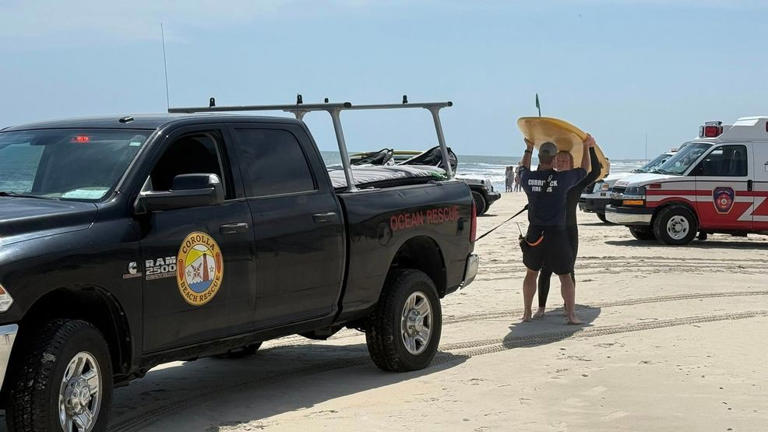 Firefighters and a lifeguard rescue mission in a beach in North Carolina