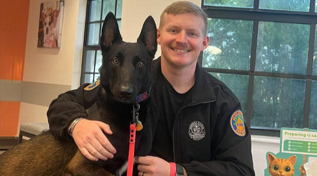Florida state trooper with a dog that he rescued on Thursday in Cape Coral Florida state trooper with a dog that he rescued on Thursday in Cape Coral