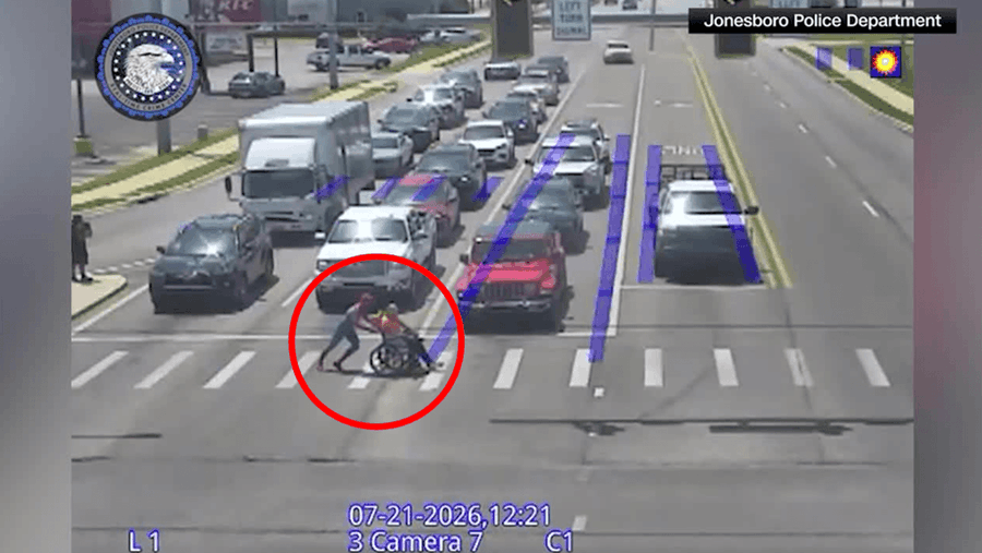 A man dressed as Spider-Man assist a man who was in a wheelchair get across the street A man dressed as Spider-Man assist a man who was in a wheelchair get across the street