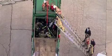 San Francisco firefighters rescue a man who was inside of a garbage truck San Francisco firefighters rescue a man who was inside of a garbage truck
