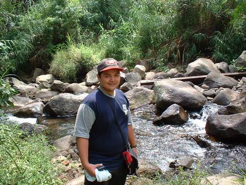 outing with my office mate - me on the small river side in west java, indonesia. i was visiting 'taman safari indonesia' - an open space zoo park.