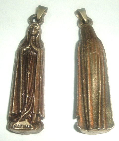 Blessed Mother Apparition in Fatima  - Blessed Mother Apparition in Fatima (2 inch Medal/Pendant)  This is something that I sell to make a little extra money. This medal measure 2 inches tall and is made out of solid brass.  This medal or pendant shows our Blessed Mother and has the word Fatima at the bottom.    The Blessed Virgin Mary, the Mother of God, appeared 6 times to 3 shepherd children; Lucia, Francisco, and Jacinta; between May 13 and October 13, 1917. She came to the little village of Fatima, which had remained faithful to the Catholic Church during the recent persecutions by the government. Our Lady came with a message from God to every man, woman, and child of our century. Our Lady of Fatima promised that the whole world would be in peace, and that many souls would go to Heaven if her requests were listened to and obeyed. She told us that war is a punishment for sin; that God would punish the world for its sins in our time by means of war, hunger, persecution of the Church and persecution of the Holy Father, the Pope, unless we listened to and obeyed the command of God. At Fatima, Pope John Paul II said on May 13; “the message of Fatima is more relevant and more urgent ' then when Our Lady first appeared. The message is an anguished appeal of our Heavenly Mother, Who sees us in great danger and who comes to offer her help and advice. Her message is also a prophesy, a clear indication of what was about to transpire in the 20th century, and what is still going to happen infallibly in the near future, depending on our response to Her requests.