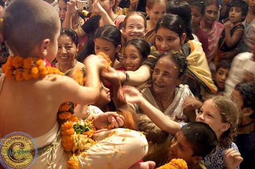 Distributing sweet - A devotee child distributing sweet food in Mayapur,India