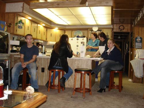 Me - This is a picture of and party at my grandpas house. I'm the one with the blonde hair sitting on the stool. I like this picture because I think it makes me look cute.