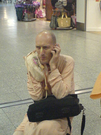 Airport - Waiting at the airport - HH Bhakti Vikasa Maharaj giving spiritual instructions on the cell phone
