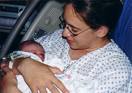 New Mama - This is my daughter, Shannon, holding baby Cayden which she'd given birth to only minutes earlier.  What a difference childbirth is today than it was when I had my children.