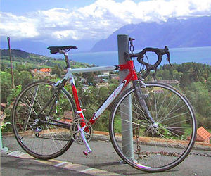 Racing Bicycle - This racing bicycle is built using lightweight, shaped aluminium tubing and carbon fiber stays and forks. It sports a drop handlebar and thin tires and wheels for efficiency and aerodynamics.
