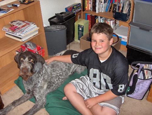 My little guy - My younger son Cody and our dog Louie in our messy office room......