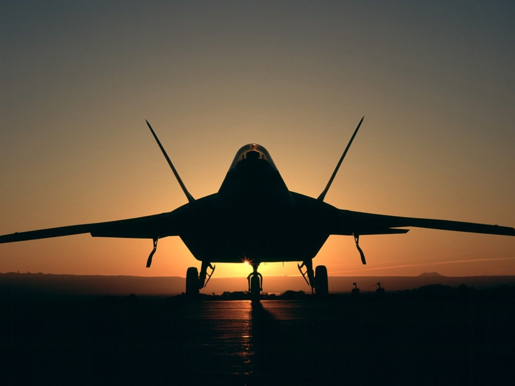 F-22 Raptor - This is F-22 raptor lookin BEAutiful in this sunset picture... This has two fins and has thrust vectoring capability... it is supposed to replace the ageing F-15 fleet of the US Air Force... Quite an agile fighter with very few able to compete with it on all performance and role capabilities....