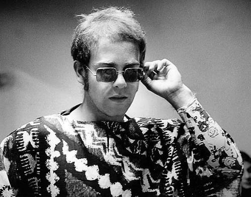 Elton John wearing glasses - His trademark are his glasses.