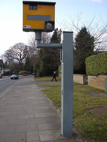 Speed camera - If you get caught speeding in the U.S., chances are good there was a state trooper standing on the side of the road wielding a radar gun. In the U.K., much of the work of detection is done by self-activated devices known as 'speed cameras.' Some British drivers are so put off by the cameras--incensed at having been caught, upset that the police aren't focusing on more serious criminal matters or wary of any form of government surveillance--that they've taken arms against them. Speed cameras have been covered by bags, knocked to the ground or even blown up.  Seen here on a side street in Watford, England, is one of the more common camera types, a Gatso.