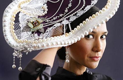 Hat carnival - Lindy Klim, wife of Michael and a Balinese princess, models a $1 million hat designed by milliner Serena Lindeman in preparation for the Spring Racing Carnival. The hat features 130 carats of cushion and brillant cut diamonds, 70 carats of precious coloured gemstones and white and gold South Sea pearls.