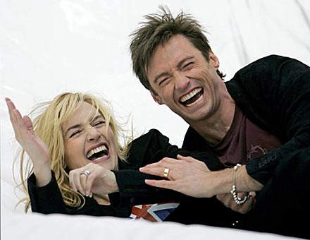Winslet & Jackman - Winslet and Jackman, who provide voices for the animated feature Flushed Away, laugh after sliding down large inflatable slide at the premiere. HUGH Jackman and Kate Winslet go to extraordinary lengths at the New York premiere of their new animated movie, Flushed Away.