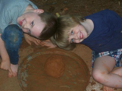 Kids and mudball. - My kids showing off 'the most biggest mudball ever mom...for real!'