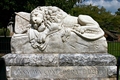 Meanings of Common Tombstone Symbols & Icons - Have you ever wandered through a cemetery and wondered about the meanings of the designs carved on old gravestones? Thousands of different religious and secular symbols and emblems have adorned tombstones through the ages, indicating attitudes towards death and the hereafter, membership in a fraternal or social organization, or an individual's trade, occupation or even ethnic identity. While many of these tombstone symbols have fairly simple interpretations, it is not always easy to determine their meaning and significance. We were not present when these symbols were carved into the stone and can't claim to know our ancestors' intentions. They may have included a particular symbol for no other reason than because they thought it was pretty.  This massive lion, known as the 'Lion of Atlanta,' guards the tomb of more than 3,000 unknown Confederate soldiers in Atlanta's historic Oakland Cemetery. The dying lion rests on the flag they followed and 'guards their dust.'Lions in the cemetery can usually be found sitting on top of vaults and tombs, watching over the final resting-place of the departed. They also represent the courage, power and strength of the deceased individual.