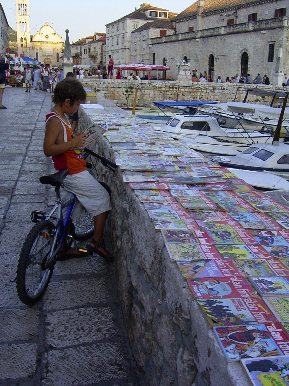 boy reading cartoons - a boy reading cartoons in Hvar, Croatia
